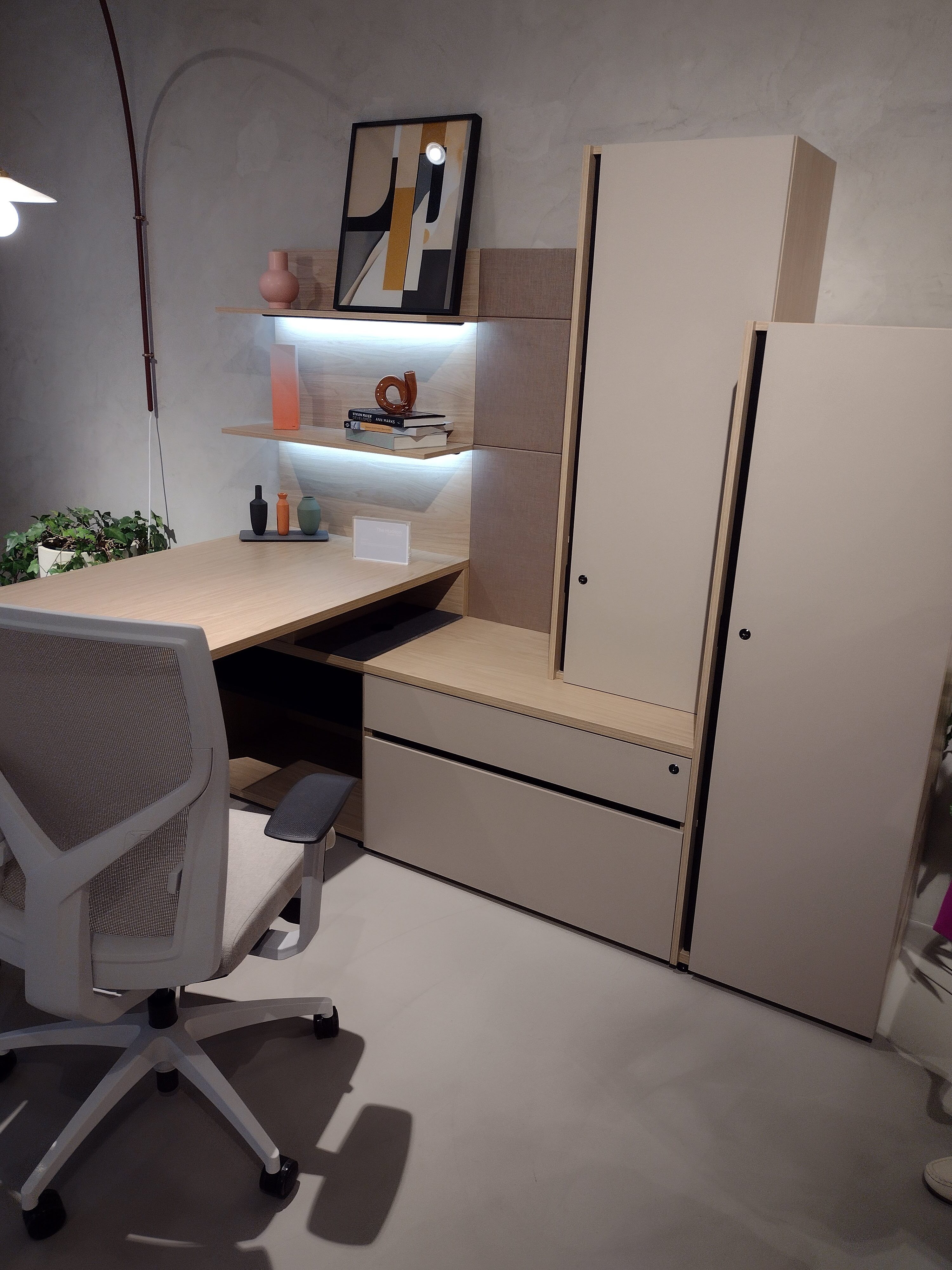 A picture of a desk and attached storage system that was on display at NeoCon