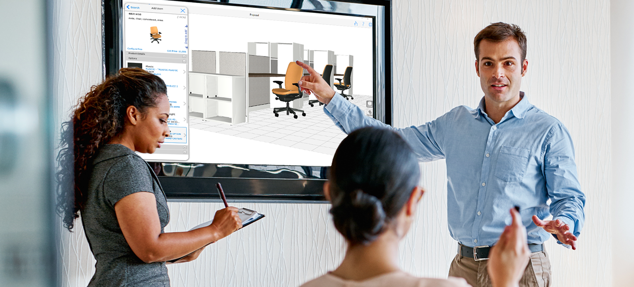 A businessman presenting using The KITS collaborator on a big TV screen to two women. 